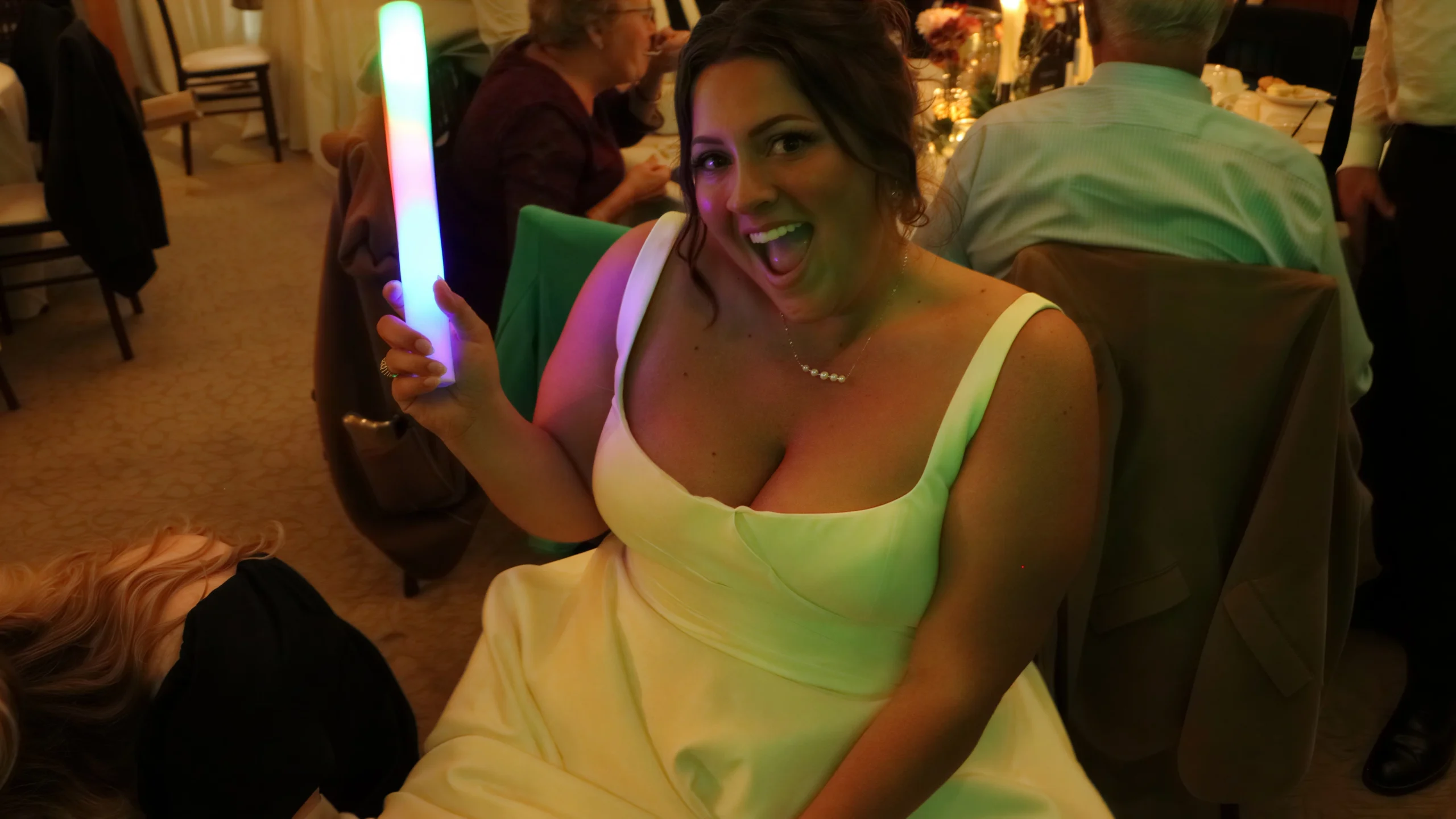 Bride waving light stick at Adirondack Wedding
