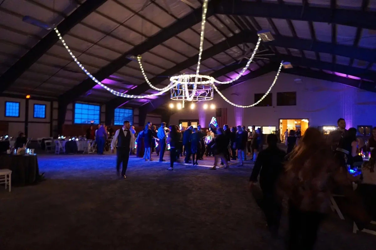 People dancing in barn wedding